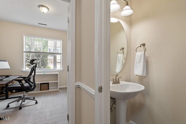 a bathroom with a sink a mirror and a window