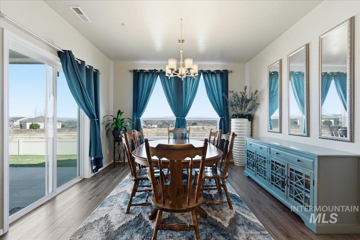 16202 Dietz Way Caldwell, ID 83607 - Photo 10 of 31 Dining room with hanging lights and dark wood finished floors