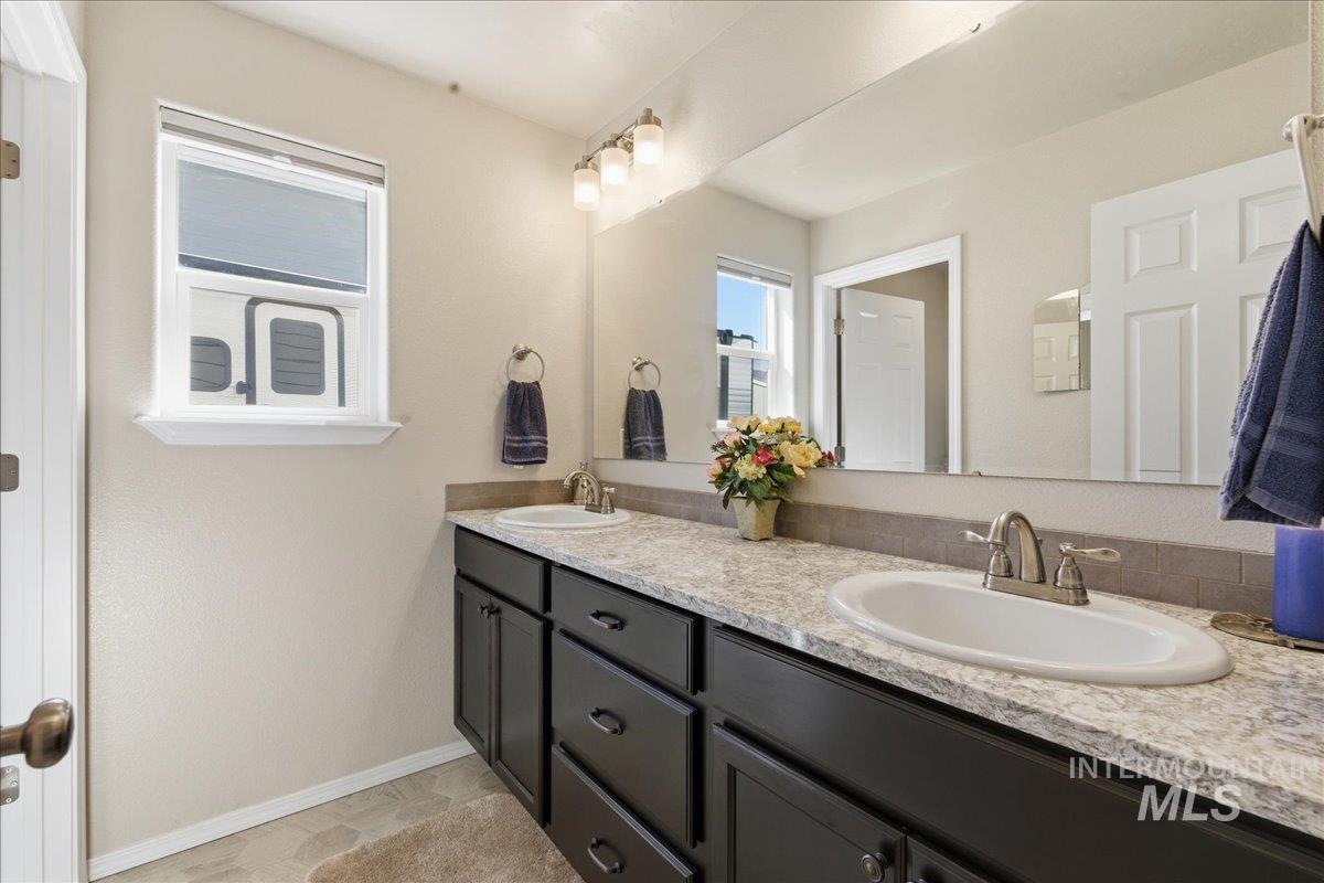 16202 Dietz Way Caldwell, ID 83607 - Photo 20 of 31 Full bathroom with double vanity and baseboards