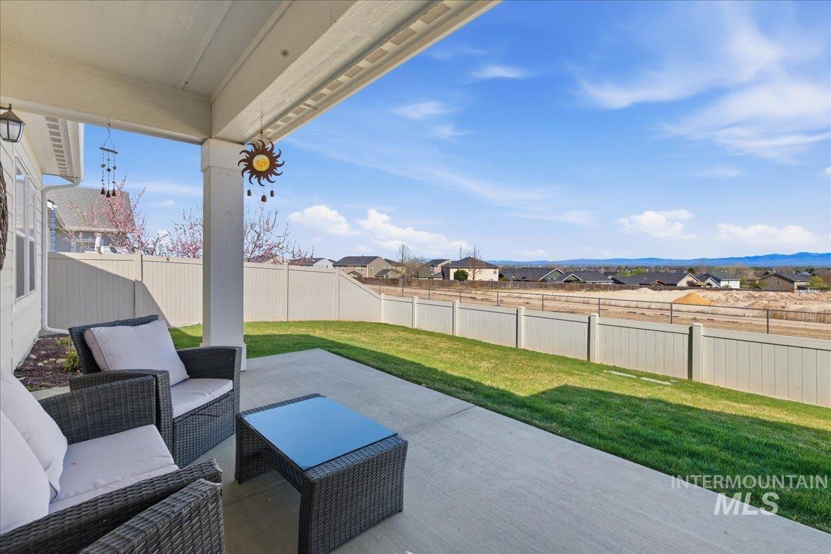 16202 Dietz Way Caldwell, ID 83607 - Photo 22 of 31 Fenced backyard with a residential view, a patio, and outdoor seating