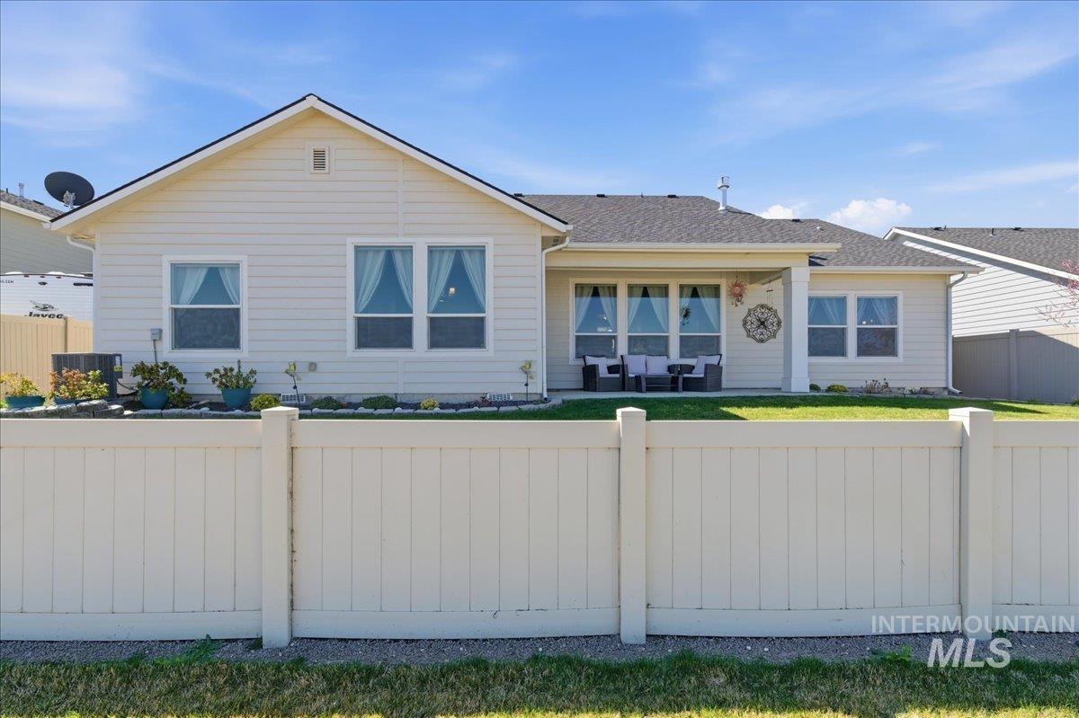 16202 Dietz Way Caldwell, ID 83607 - Photo 27 of 31 Single story home featuring a fenced front yard, a patio, and roof with shingles