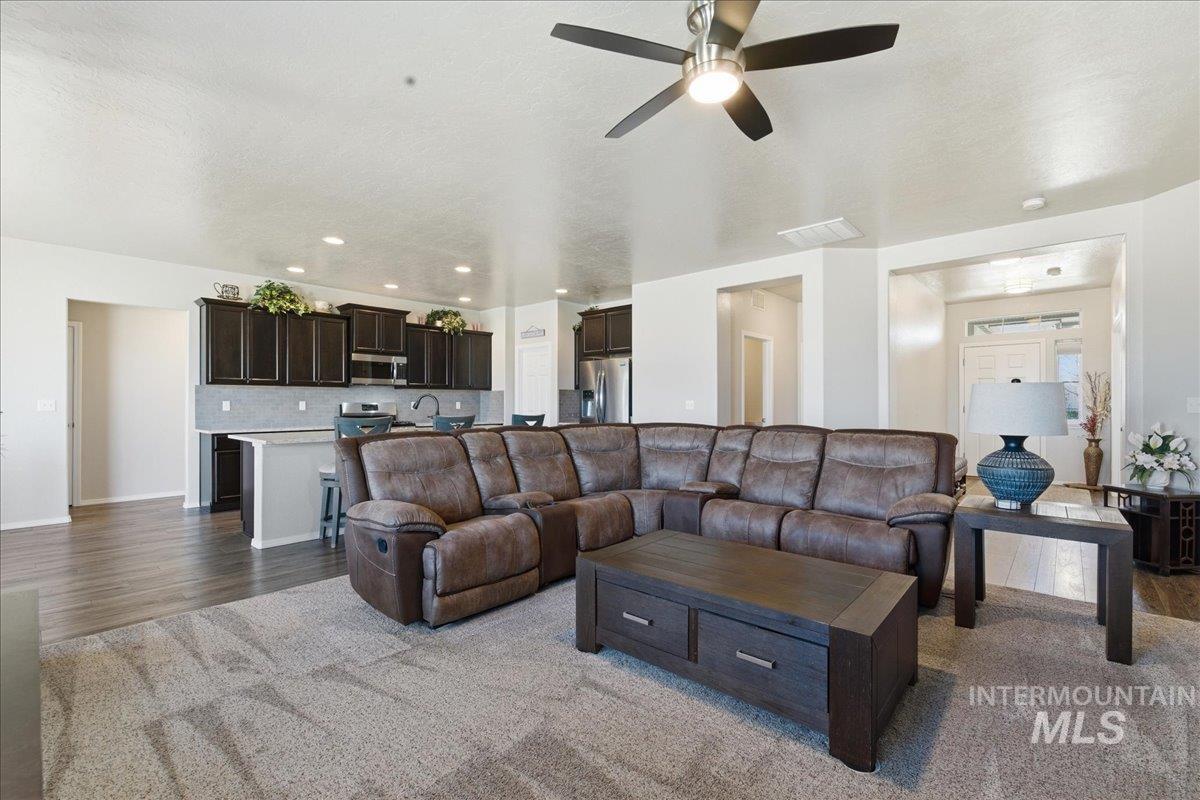 16202 Dietz Way Caldwell, ID 83607 - Photo 5 of 31 Living room featuring dark wood finished floors, ceiling fan, and recessed lighting