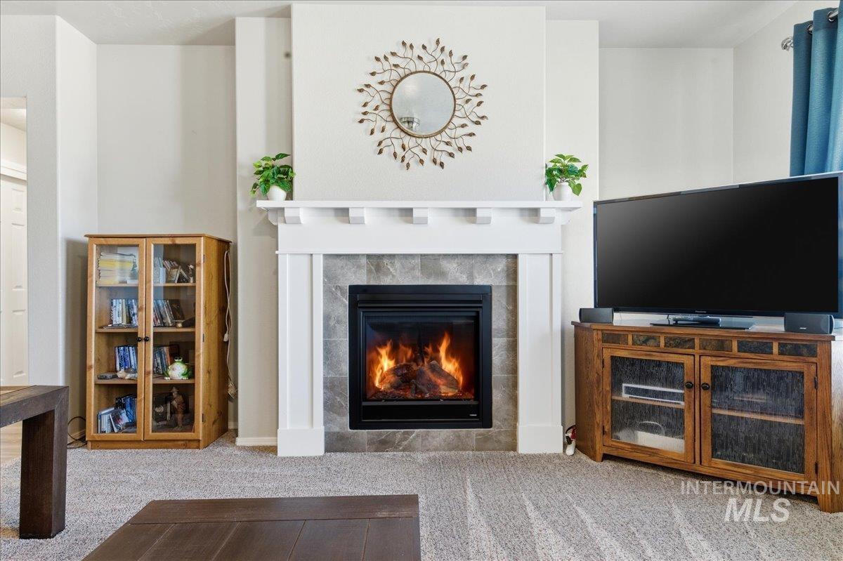 16202 Dietz Way Caldwell, ID 83607 - Photo 6 of 31 Living room with light colored carpet and a fireplace