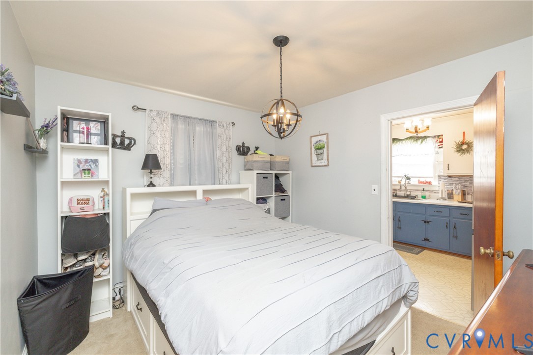 24601 Callear Road Petersburg, VA 23803 - Photo 12 of 32 a spacious bedroom with a bed and a dresser