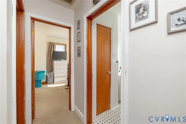 a view of a hallway with wooden floor and entryway