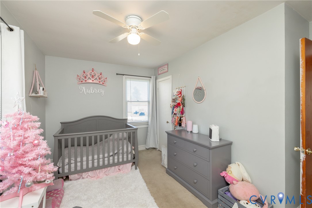 24601 Callear Road Petersburg, VA 23803 - Photo 18 of 32 a bedroom with a bed and wooden floor
