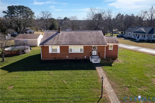 an aerial view of a house with a swimming pool