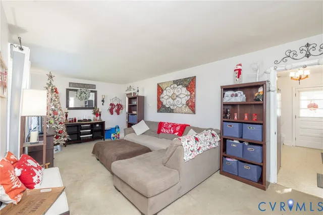 a living room with furniture and book shelf
