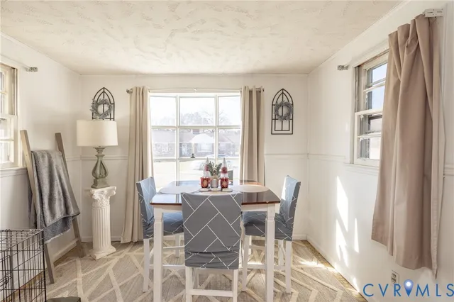 a dining room with furniture and window