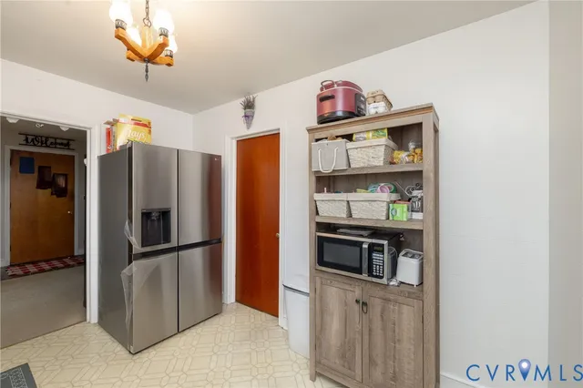 a kitchen with stainless steel appliances a refrigerator and a stove top oven