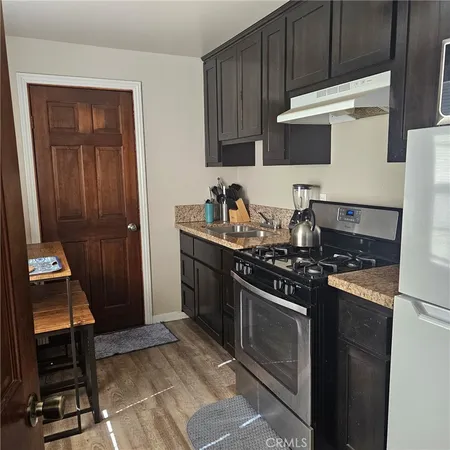 a kitchen with granite countertop a stove and a sink