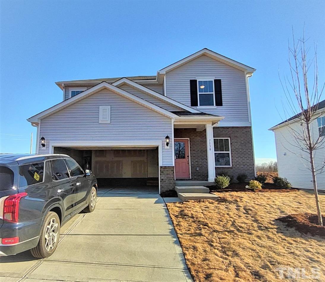 7138 Stratified Court Mebane, NC 27302 - Photo 1 of 6 a front view of a house with a yard