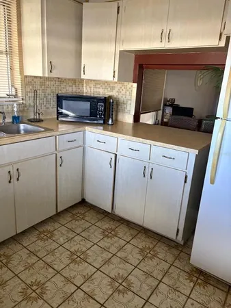 a kitchen with a sink and cabinets
