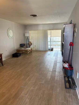 a view of a workspace with furniture and wooden floor