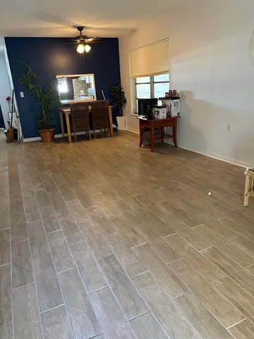 a living room with furniture a dining table and a fireplace