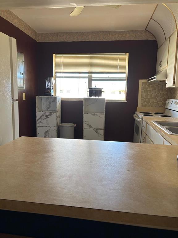 1900 South Kanner Highway, Unit 5204 Stuart, FL 34994 - Photo 5 of 25 a kitchen with stainless steel appliances a refrigerator a sink and a stove