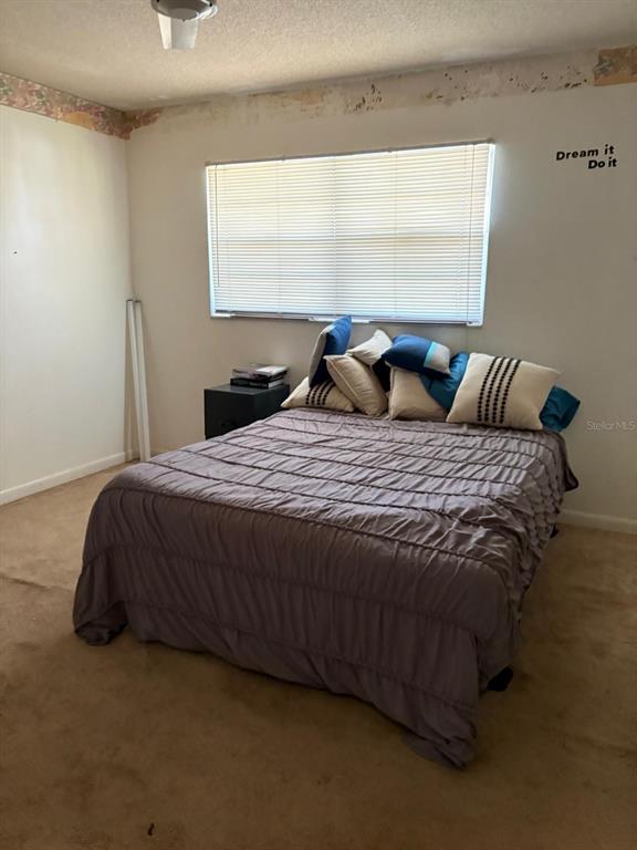 1900 South Kanner Highway, Unit 5204 Stuart, FL 34994 - Photo 8 of 25 a bed sitting in a bedroom next to a window