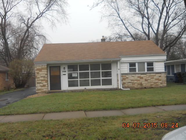 17560 Howe Avenue Homewood, IL 60430 - Photo 1 of 9 a front view of a house with a garden