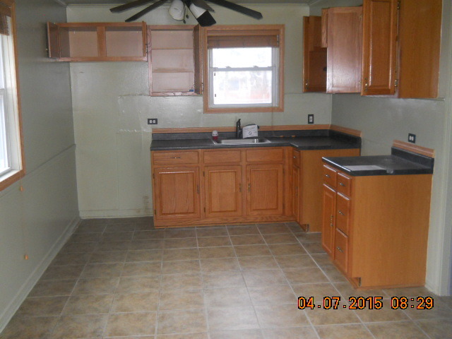 17560 Howe Avenue Homewood, IL 60430 - Photo 6 of 9 a kitchen with granite countertop a sink a stove a microwave and cabinets