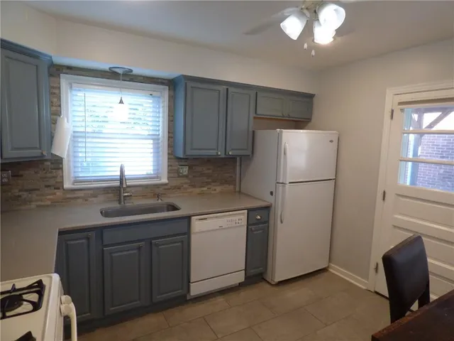 a kitchen with appliances a sink and a window