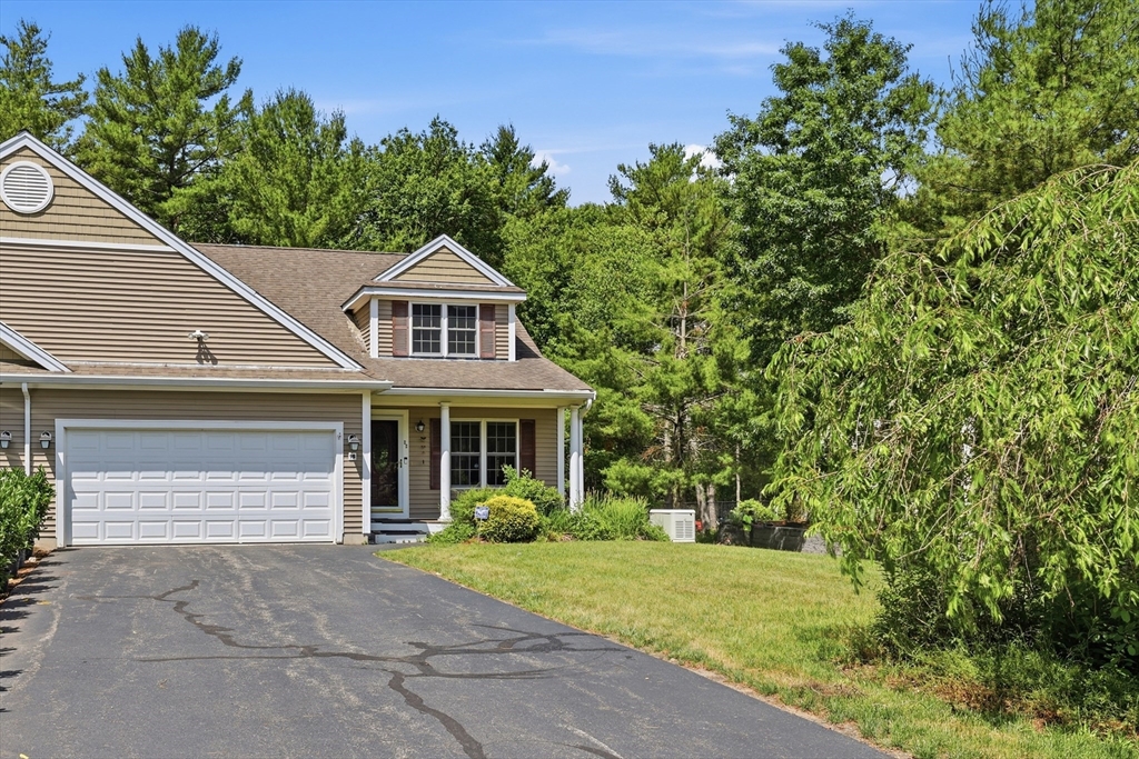 9 Rock Marsh Road, Unit B Wareham, MA 02571 - Photo 36 of 41 a front view of a house with a yard and garage