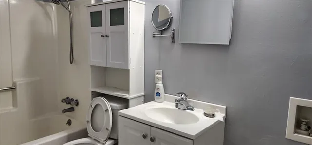 a bathroom with a toilet and a shower