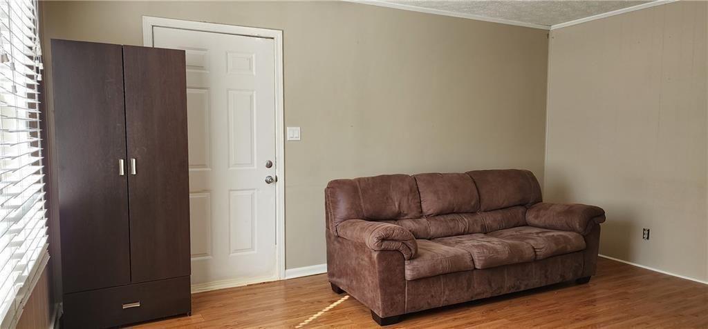 205 Glenview Terrace Winder, GA 30680 - Photo 3 of 31 a living room with furniture and a refrigerator