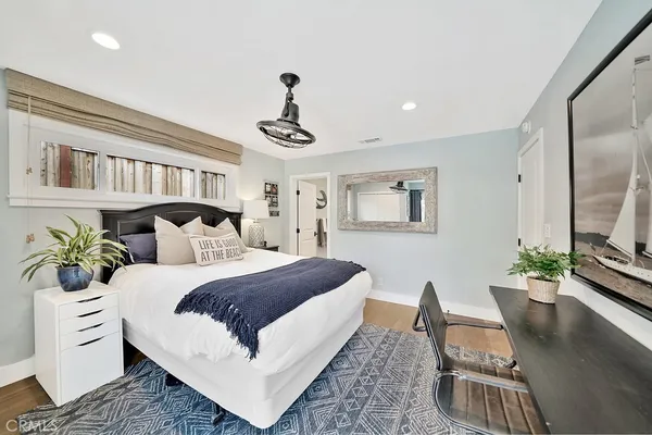 a bed room with bed and a potted plant