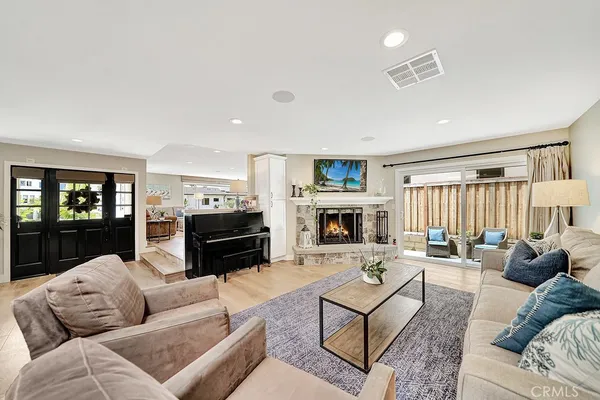 a living room with furniture a fireplace and a flat screen tv