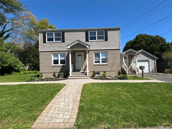 a front view of a house with a yard