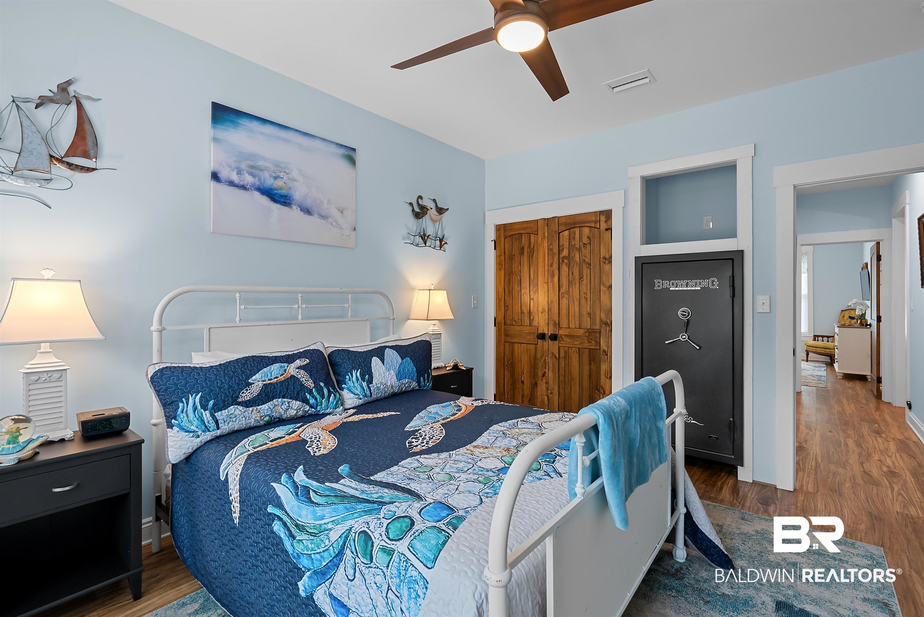 7266 Franklin Road Foley, AL 36535 - Photo 35 of 64 Bedroom featuring wood-finish flooring, a ceiling fan with integrated lighting, and a closet with double wood doors