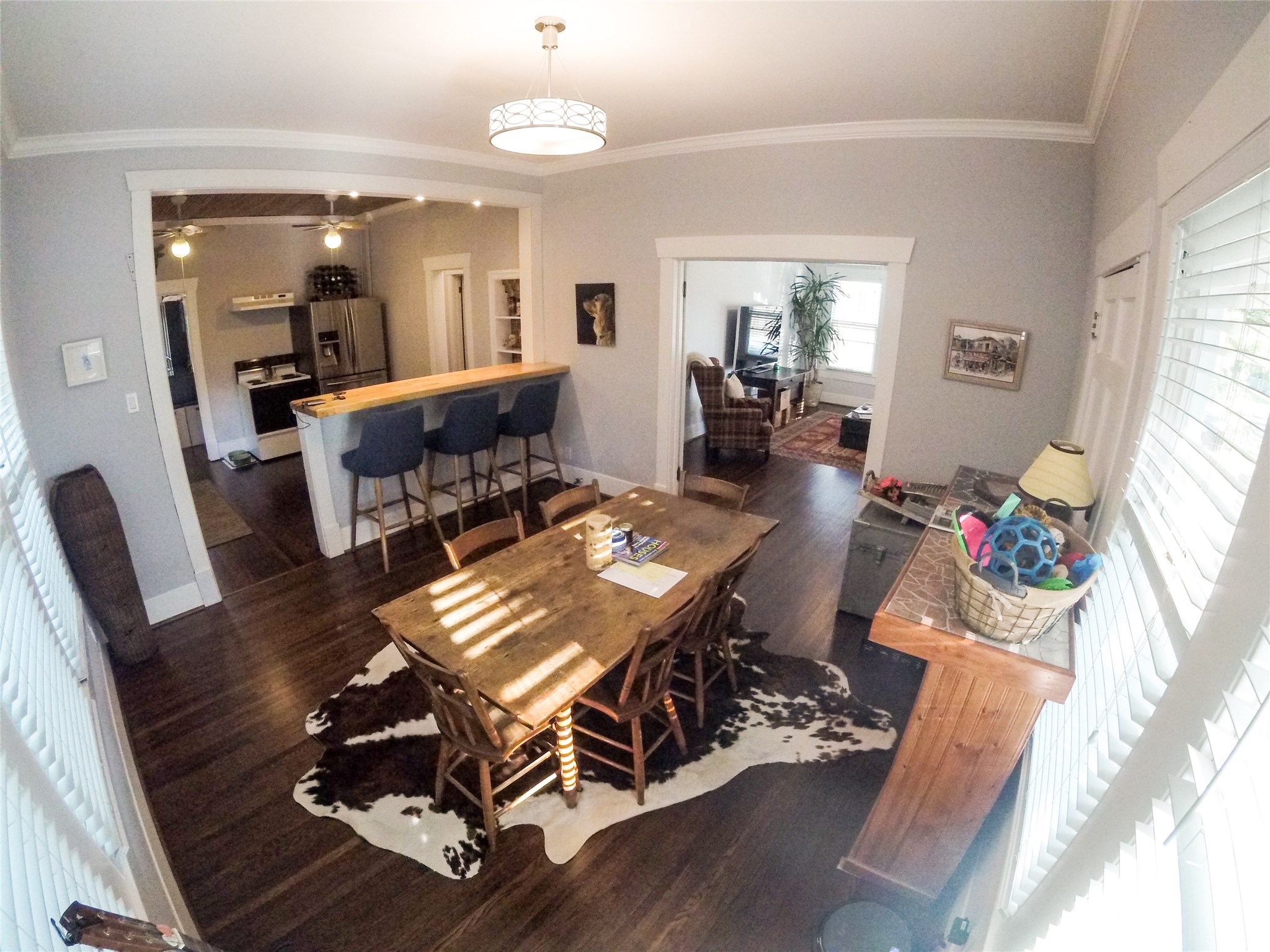 210 Tabor Street Houston, TX 77009 - Photo 9 of 20 a view of a dining room with furniture wooden floor and a chandelier