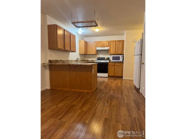 a bathroom with a sink a mirror and wooden floor