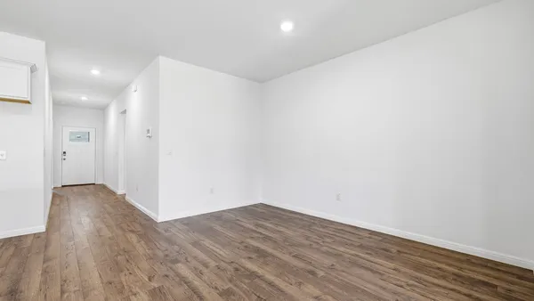 a view of a room with wooden floor