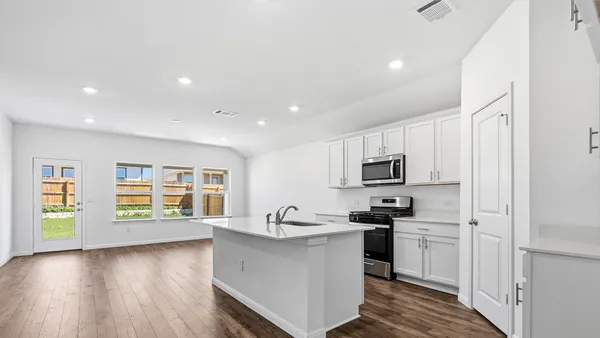 a kitchen with microwave and stove
