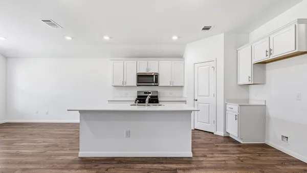 a kitchen with stainless steel appliances a sink stove and refrigerator