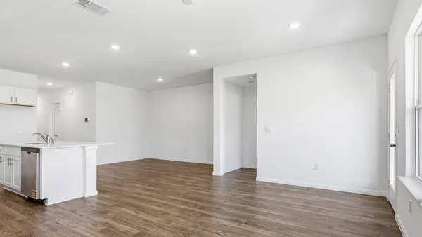 a view of a kitchen with wooden floor