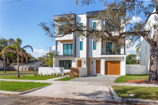 a front view of a house with a garden and plants