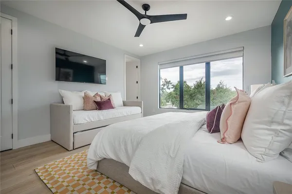 a bedroom with a large bed and a flat screen tv