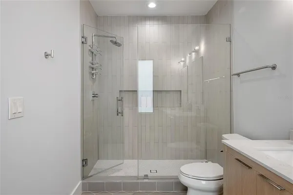 a bathroom with a shower a toilet and sink