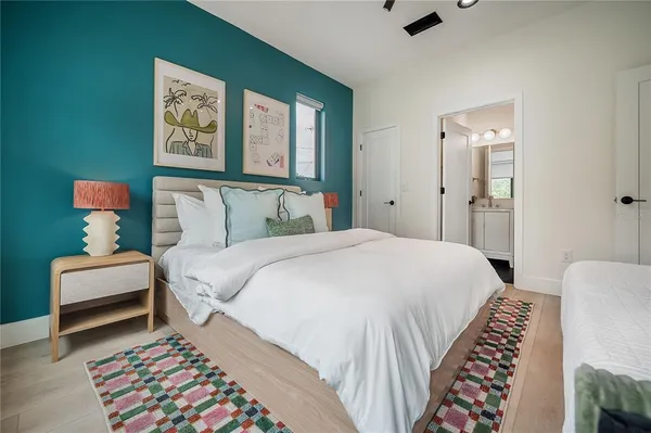 a bedroom with a bed and a painting on the wall