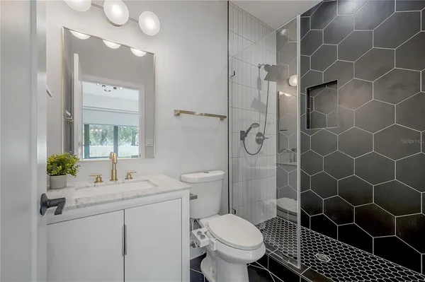 a bathroom with a sink toilet and shower