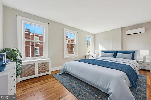 a bedroom with a large bed and windows