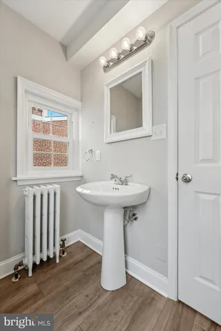 a bathroom with a sink a mirror and shower