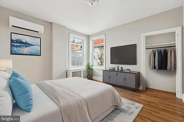 a bedroom with a flat screen tv and a bed