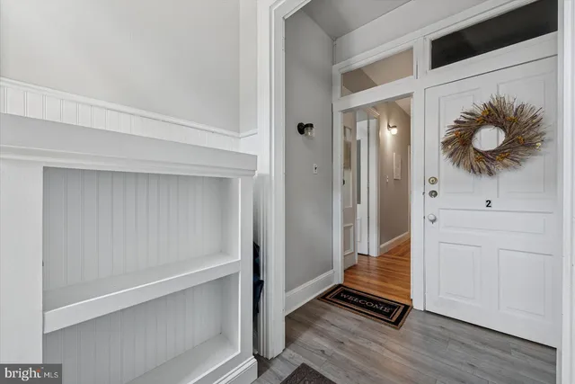 a view of front door with wooden floor