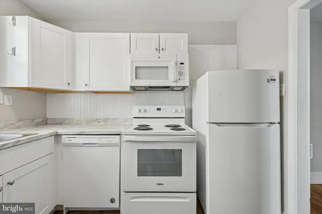 a white refrigerator freezer sitting in a kitchen