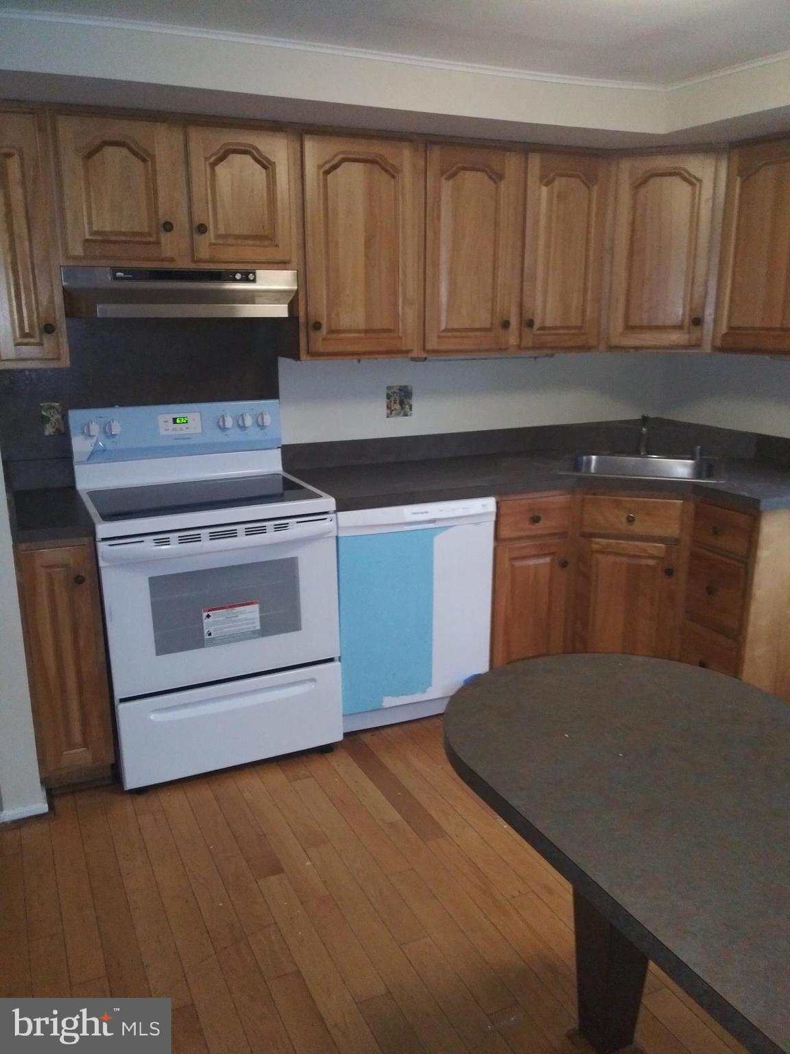 405 Trimble Road Joppa, MD 21085 - Photo 2 of 5 a kitchen with stainless steel appliances granite countertop a stove a sink and a microwave