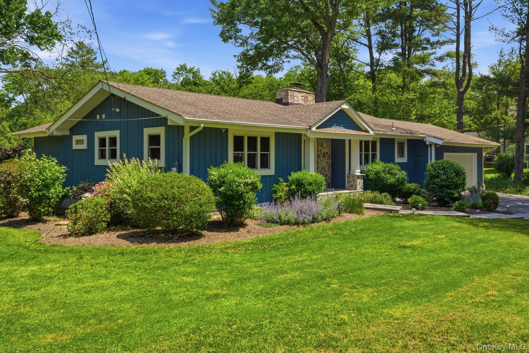 35 Deans Bridge Road Somers, NY 10589 - Photo 36 of 49 Lush, layered landscaping and a classic board-and-batten exterior give this single-level home curb appeal that turns heads.