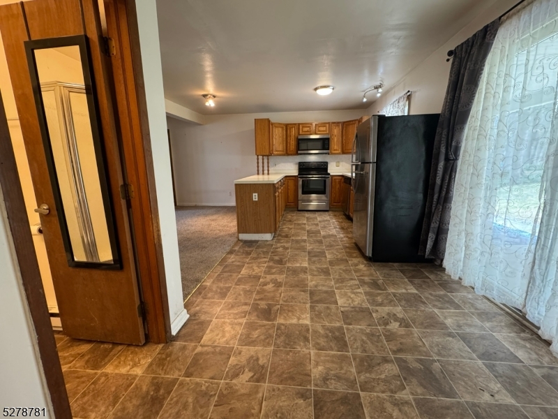 261 Old Chimney Ridge Road, Unit A Montague, NJ 07827 - Photo 13 of 43 a view of kitchen with refrigerator and window